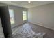 Comfortable bedroom with a light-filled feel, featuring neutral carpet and two bright windows at 41 W Emily Gardens Dr, Selma, NC 27576