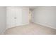 Bedroom showcasing neutral carpeting, a double door closet, and access to additional rooms at 41 W Emily Gardens Dr, Selma, NC 27576