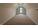 Large upstairs bonus room offers versatile space with neutral walls, plush carpet and natural light at 41 W Emily Gardens Dr, Selma, NC 27576