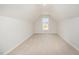 Cozy bonus room with carpet flooring and window with a view of the neighborhood at 41 W Emily Gardens Dr, Selma, NC 27576