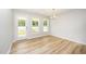 Bright dining area featuring wood floors, chandelier lighting, and a door leading to the backyard at 41 W Emily Gardens Dr, Selma, NC 27576