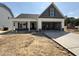 Charming single-story home featuring a light grey exterior, an attached garage, and a well-manicured front yard at 41 W Emily Gardens Dr, Selma, NC 27576