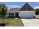Charming one-story home with a two-car garage, landscaped yard, and inviting covered front porch at 41 W Emily Gardens Dr, Selma, NC 27576