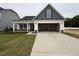 Charming home with gray and white siding, a spacious driveway, and an attached two-car garage at 41 W Emily Gardens Dr, Selma, NC 27576