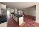 Open-concept kitchen featuring an island, white cabinets, modern fixtures, and an adjacent living area at 41 W Emily Gardens Dr, Selma, NC 27576