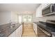 Kitchen with stainless appliances, granite countertops, and adjacent dining area at 41 W Emily Gardens Dr, Selma, NC 27576