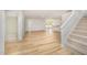 Open-concept living area with hardwood floors, staircase, and natural light streaming through the windows at 41 W Emily Gardens Dr, Selma, NC 27576