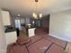 Open floor plan showcasing the kitchen with its island and chandelier above the future dining area at 41 W Emily Gardens Dr, Selma, NC 27576