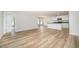 Spacious living room with views of the kitchen, modern hardwood floors, and white walls at 41 W Emily Gardens Dr, Selma, NC 27576