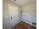 A practical mudroom with a door to the exterior, shelving and utility connections at 41 W Emily Gardens Dr, Selma, NC 27576