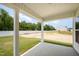 Covered patio offering an inviting outdoor space with green lawn and backyard views at 41 W Emily Gardens Dr, Selma, NC 27576