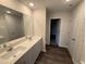 Bright bathroom featuring double sinks, granite countertops, wood floor, and plenty of space at 43 Chloe Ct, Selma, NC 27576