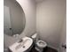 Compact bathroom with stylish sink, toilet, and round mirror, creating a functional and modern space at 43 Chloe Ct, Selma, NC 27576