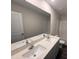 Bathroom with double sink vanity, white countertop, large mirror, and a tub and shower at 43 Chloe Ct, Selma, NC 27576