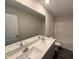 Clean bathroom with a double sink vanity, large mirror, and updated fixtures at 43 Chloe Ct, Selma, NC 27576