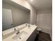 Bathroom featuring double sinks, granite countertops, shower and bath combo, wood flooring, and privacy at 43 Chloe Ct, Selma, NC 27576