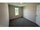 Cozy bedroom features neutral carpet, paint, and a window allowing natural light at 43 Chloe Ct, Selma, NC 27576