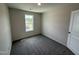 Cozy bedroom with neutral carpet, a large window and a door at 43 Chloe Ct, Selma, NC 27576