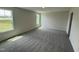 Cozy bedroom featuring two windows and soft, neutral carpeting for a warm and inviting space at 43 Chloe Ct, Selma, NC 27576
