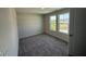 Sunny bedroom featuring neutral carpet and two windows overlooking the backyard at 43 Chloe Ct, Selma, NC 27576