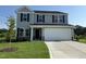 Charming two-story home with gray siding, a two-car garage, and a well-manicured lawn at 43 Chloe Ct, Selma, NC 27576