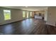 A spacious kitchen and living room area with white cabinets and an island at 43 Chloe Ct, Selma, NC 27576