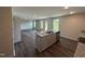 Modern kitchen island with stainless steel appliances, granite countertops, and ample cabinet space at 43 Chloe Ct, Selma, NC 27576