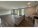 Kitchen with island featuring granite countertop, stainless sink, and ample room to entertain and enjoy the scenery at 43 Chloe Ct, Selma, NC 27576