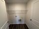 Functional laundry room featuring a wire rack shelf and sleek, modern doors at 43 Chloe Ct, Selma, NC 27576