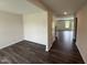 Living room featuring wood flooring, base trim, neutral colored walls and an open concept to the dining area at 43 Chloe Ct, Selma, NC 27576