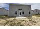 View of the backyard with patio and gray siding, showing the outdoor space of the property at 43 Chloe Ct, Selma, NC 27577