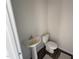 Half bathroom featuring a pedestal sink, toilet, and dark colored wood flooring at 43 Chloe Ct, Selma, NC 27577