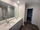 Bathroom featuring a double sink vanity with gray cabinets and a large mirror at 43 Chloe Ct, Selma, NC 27577