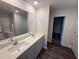 Elegant bathroom featuring double sinks, granite countertops, and a large mirror for added convenience at 43 Chloe Ct, Selma, NC 27576