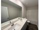 Modern bathroom featuring dual sinks, a spacious mirror, and a shower and tub combo at 43 Chloe Ct, Selma, NC 27576