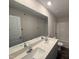 Bathroom featuring a double sink vanity with granite countertops and a shower/tub combo at 43 Chloe Ct, Selma, NC 27577