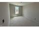 Bedroom with a single window for natural light, bare walls, and concrete flooring at 43 Chloe Ct, Selma, NC 27577