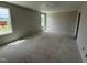 Spacious bedroom with natural light, bare walls, and concrete flooring at 43 Chloe Ct, Selma, NC 27577