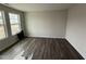 Bright bedroom featuring hardwood floors, white trim, and large windows at 43 Chloe Ct, Selma, NC 27577
