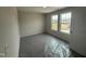 Bright bedroom with carpet, plastic covering, two windows, and light walls at 43 Chloe Ct, Selma, NC 27577