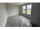 A bright bedroom featuring neutral walls, carpeted floors, and three windows letting in natural light at 43 Chloe Ct, Selma, NC 27577