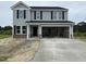 Two-story home with gray siding, black shutters, and a spacious two-car garage at 43 Chloe Ct, Selma, NC 27577