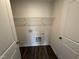 Functional laundry room with white walls and a metal shelf for storage at 43 Chloe Ct, Selma, NC 27576