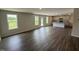 Open-concept living room with hardwood floors, leading into a kitchen with white cabinets and an island at 43 Chloe Ct, Selma, NC 27576