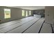 Spacious living room and kitchen area featuring three large windows and a center island at 43 Chloe Ct, Selma, NC 27577