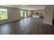 Open-concept living space with wood-look flooring, lots of natural light, and a view of the kitchen at 43 Chloe Ct, Selma, NC 27577