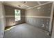 Unfinished room featuring newly installed drywall and trim and a single window providing natural light at 43 Chloe Ct, Selma, NC 27577