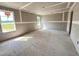 Unfinished room featuring newly installed drywall and trim and two windows providing natural light at 43 Chloe Ct, Selma, NC 27577