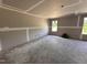 Unfinished room featuring newly installed drywall and trim and two windows providing natural light at 43 Chloe Ct, Selma, NC 27577