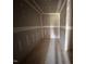 Unfinished closet area featuring newly installed drywall and trim with bare plywood flooring at 43 Chloe Ct, Selma, NC 27577